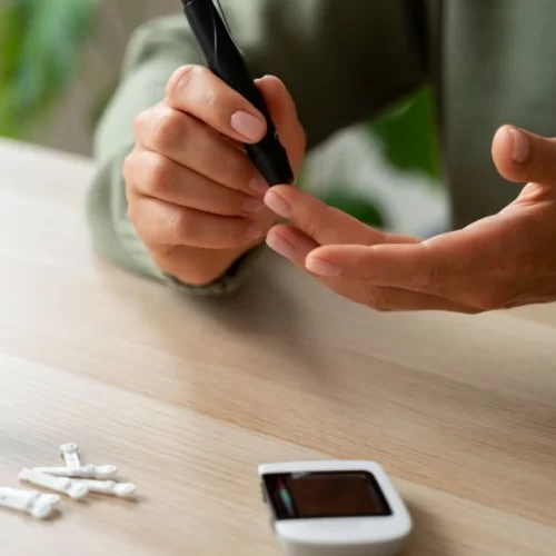 A person testing blood sugar levels with a glucometer
